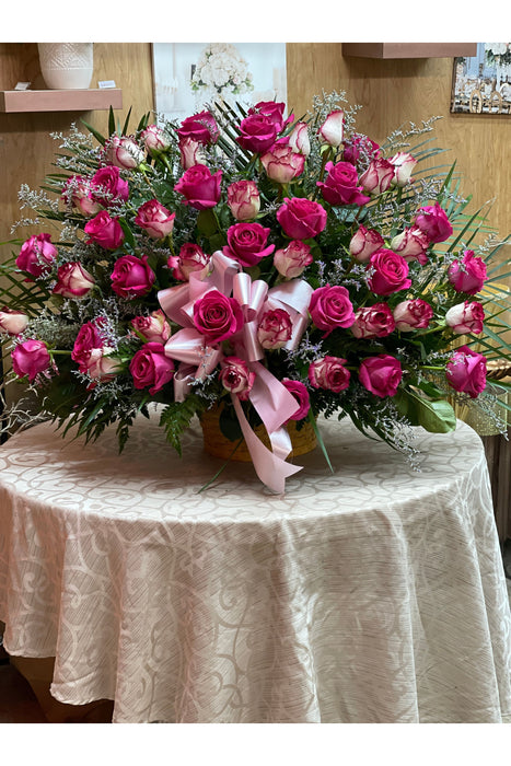 Elegant funeral floor basket filled with a lush display of roses, handcrafted by a Brooklyn florist for a heartfelt tribute.